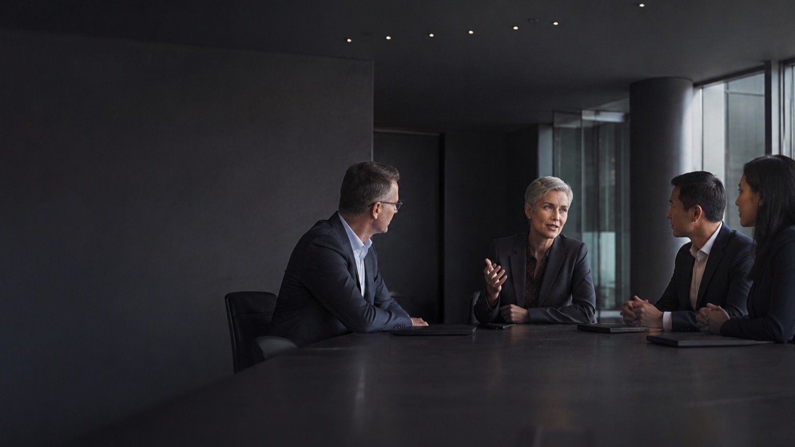 Senior leaders in a thoughtful succession discussion in a global boardroom